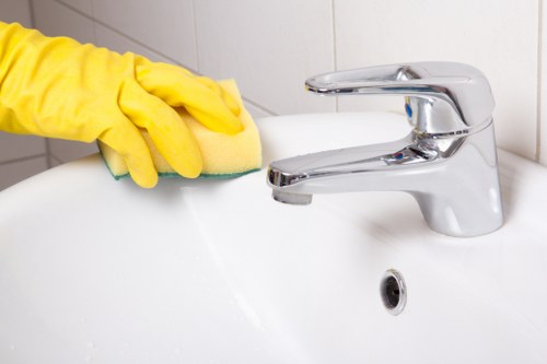Cleaner preparing a guest-ready Airbnb living room in Richmond upon Thames